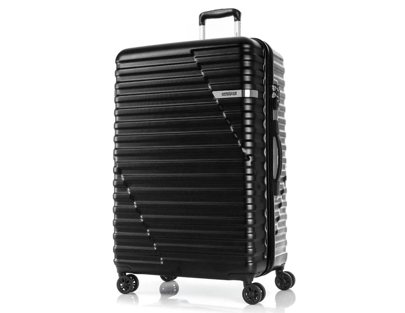 A sleek black suitcase with a textured diagonal design, featuring a retractable handle and four smooth-rolling wheels. The suitcase is upright, showcasing its spacious construction suitable for travel.