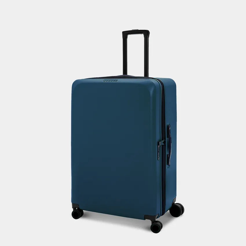 A sleek, blue suitcase stands upright with a retractable handle and four smooth, double wheels. The luggage features a minimalist design, showcasing a durable exterior and a zippered compartment for easy access.