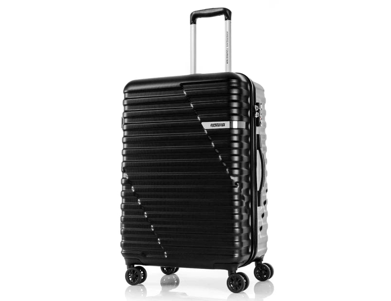 A sleek black suitcase with a textured exterior and a diagonal stripe pattern stands upright on four double wheels. The retractable handle is extended, showcasing its modern design, ideal for travel.