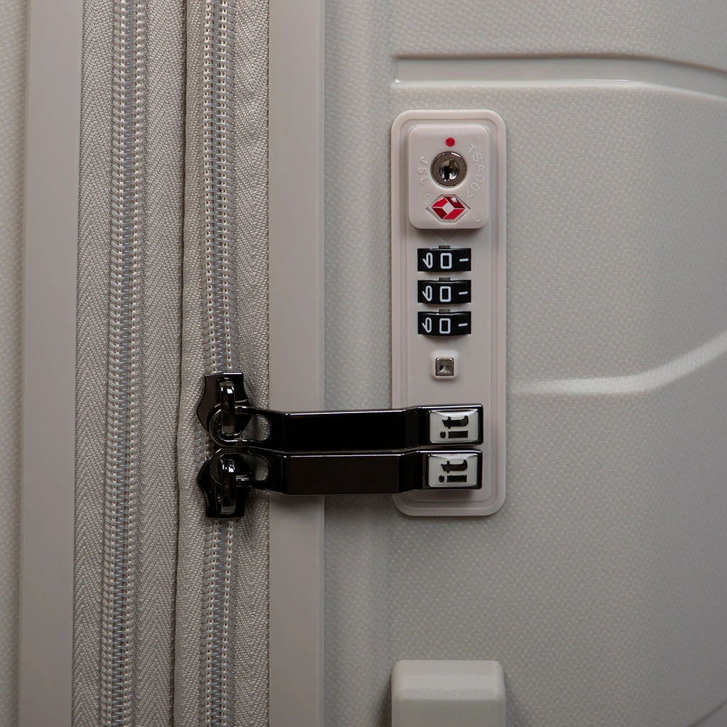 Close-up view of a TSA-compatible lock on a lightweight suitcase, featuring a numeric keypad and a dual zipper system. The lock is securely fastened, ensuring the contents of the suitcase are safe during travel.